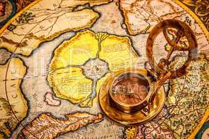 vintage compass lies on the ancient map of the north pole (also