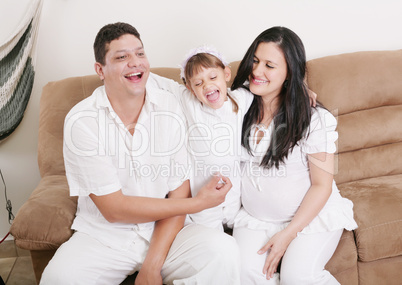 happy american family playing with daughter in the living room