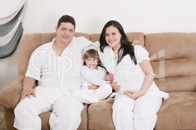 pregnant couple enjoying with their daughter