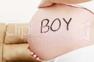 word boy written on pregnant belly