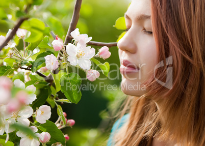 young girl smelling blossoms