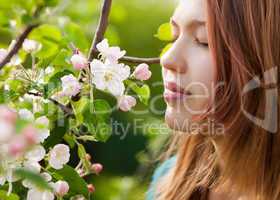 young girl smelling blossoms