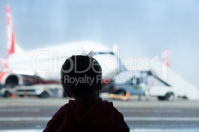 little boy watching planes at the airport
