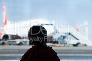 little boy watching planes at the airport