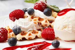 waffle with cream, ice cream and fresh berries