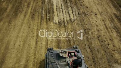 Tank riding down dirt path