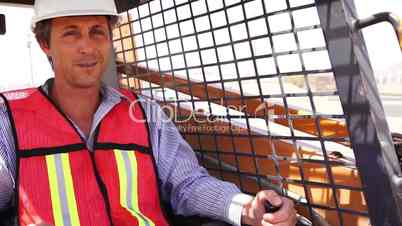 industrial male worker on skidsteer