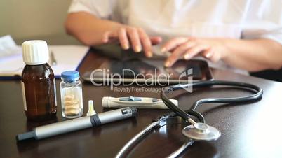 Female doctor working with digital tablet in office