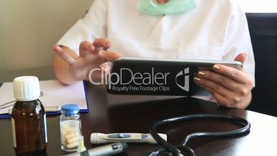 female doctor working with digital tablet in office