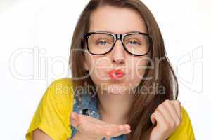 girl in geek glasses blowing kiss isolated