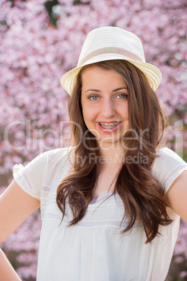girl with braces wearing hat spring blossom