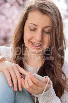 student with braces listening to music