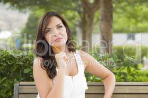 Young Adult Female Student on Bench Outdoors