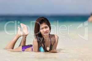 filipina woman lying on sand