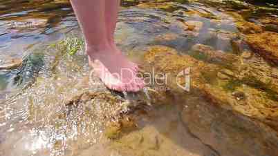 woman walking on the sea rocks