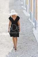 beautiful woman in hat & black dress