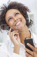 african american girl listening to mp3 player headphones