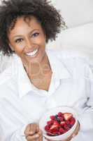 mixed race african american woman eating fruit