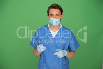 Male doctor or nurse looking at his gloved hand