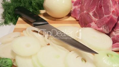 dolly: sliced fresh pork meat and vegetables on wooden cutting board