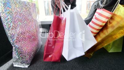 Woman loading her car trunk with shopping bags