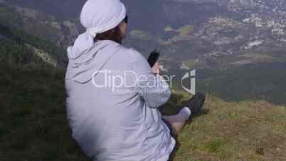 Hiker listening to music on the mountain top