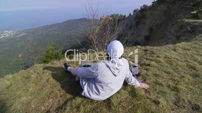 Female hiker with backpack enjoying the view from top of mountain