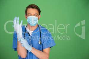 Doctor putting on surgical gloves