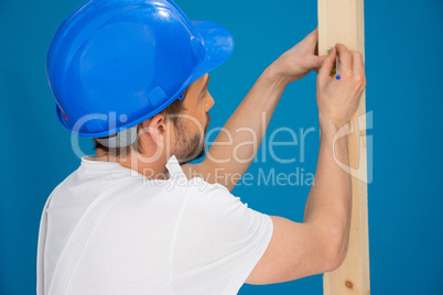 Carpenter or joiner marking a measurement