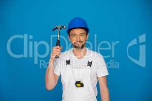 Smiling workman holding up a hammer