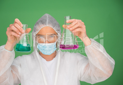 Laboratory technician holding up chemicals