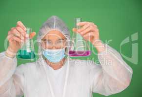 Laboratory technician holding up chemicals