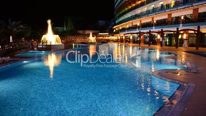 The swimming pool with fountains in night illumination at luxury hotel, Antalya, Turkey