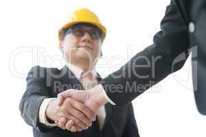 senior male architect hand shaking