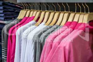 Clothing on hangers in shop