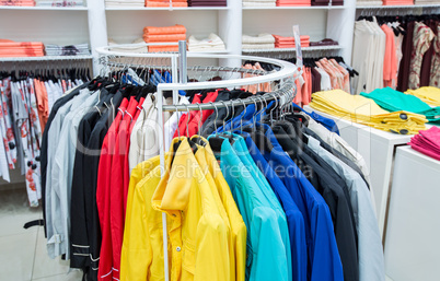 Clothing on hangers in shop