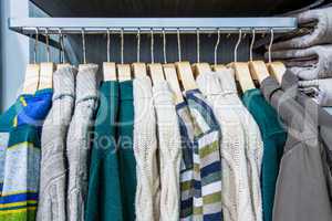 Clothing on hangers in shop