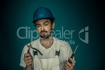 Workman standing eyeing his tools