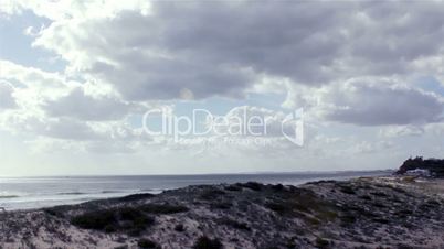 timelapse with clouds and sea Dunas Douradas beach, famous destination in Algarve, Portugal.