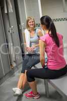 woman sitting with friend in locker room