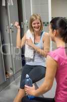 woman showing muscles in gym's locker room