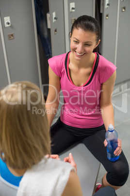 woman sitting opposite friend in changing room