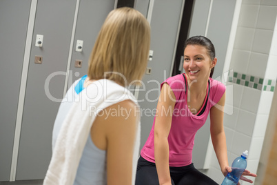 smiling woman talking with friend changing room