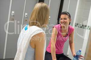 smiling woman talking with friend changing room