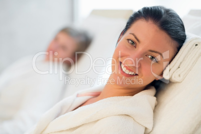 smiling woman resting at beauty spa room