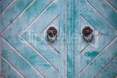 Metal round handles on wooden door