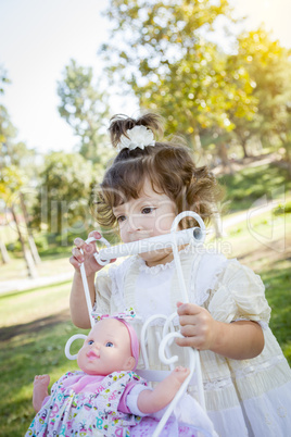 Adorable Young Baby Girl Playing with Baby Doll and Carriage