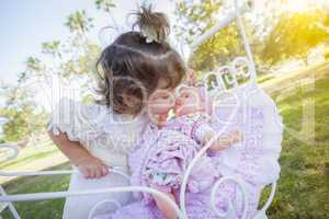 Adorable Young Baby Girl Playing with Baby Doll and Carriage