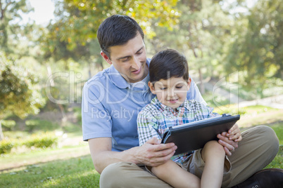 Handsome Mixed Race Father and Son Playing on Computer Tablet