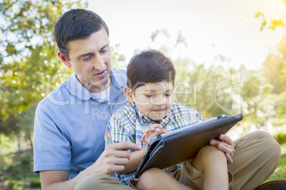 Handsome Mixed Race Father and Son Playing on Computer Tablet